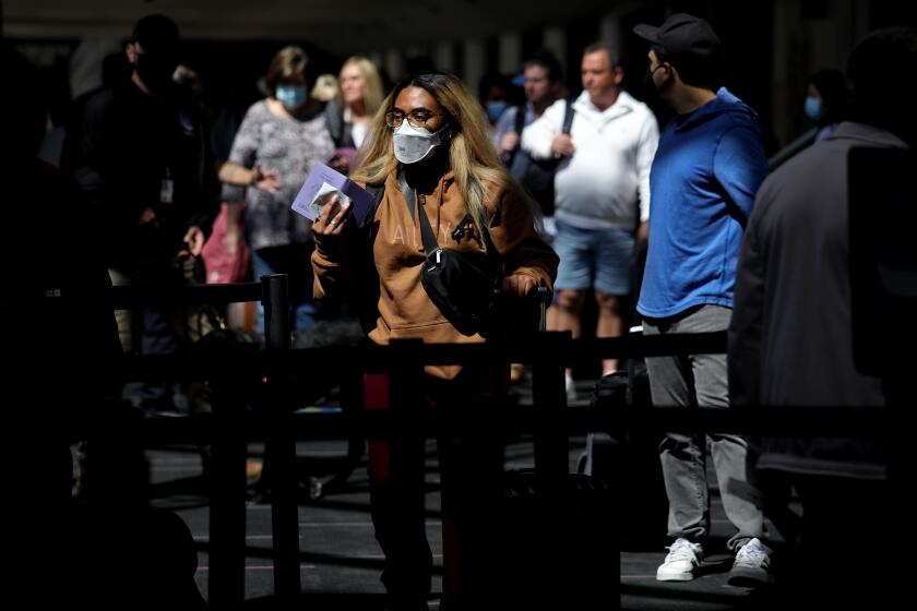LOS ANGELES, CA - APRIL 19: Passengers make their way through Delta Airlines Terminal Two at Los Angeles International Airport on Tuesday, April 19, 2022 in Los Angeles, CA. Airports and airlines dropped their mask requirements after a Florida federal judge voided the Biden administration's mask mandate for planes, trains and buses. (Gary Coronado / Los Angeles Times)