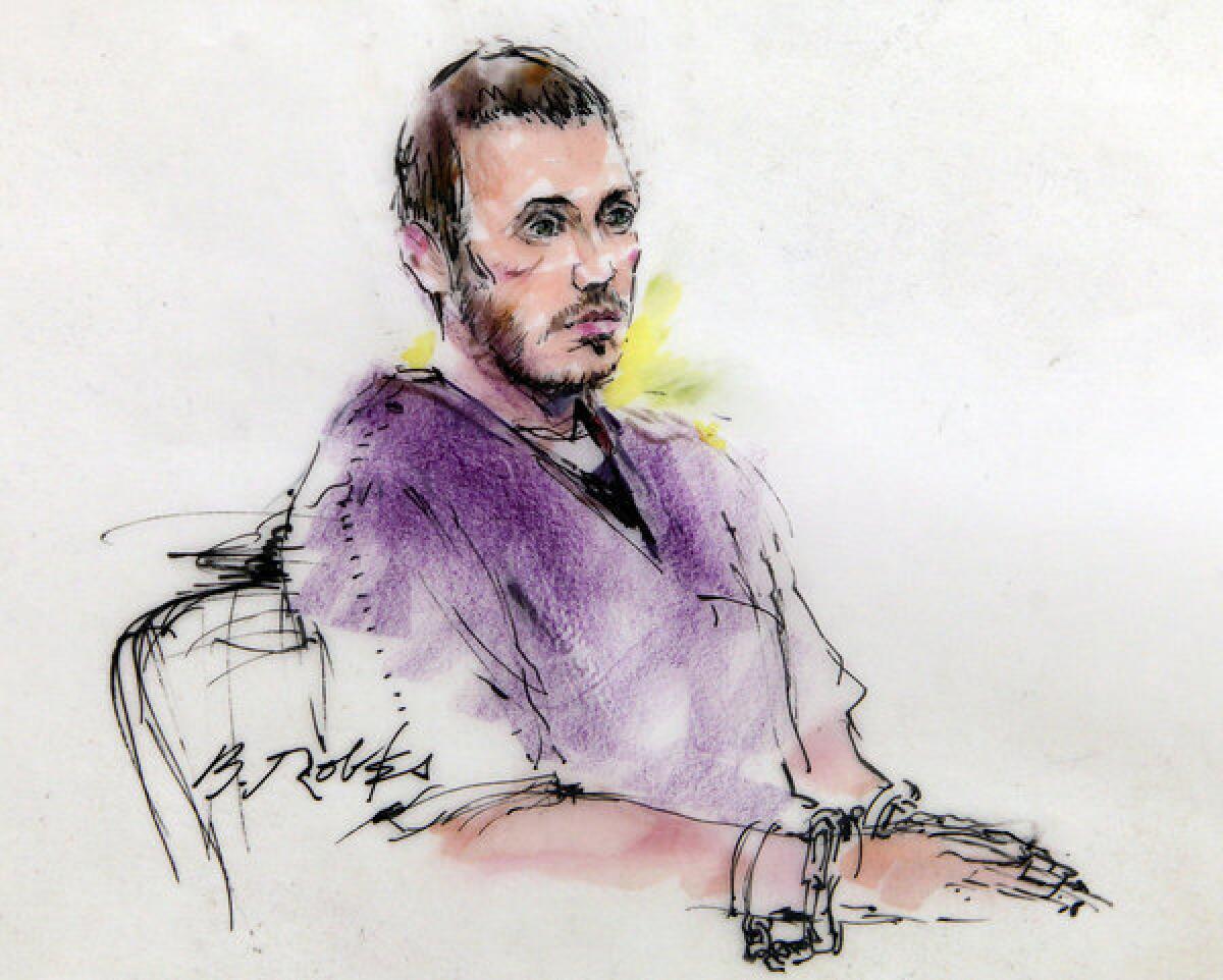 James E. Holmes, shown in a courtroom sketch from a court hearing in September, is accused of killing 12 during a shooting rampage at a movie theater in Aurora, Colo.