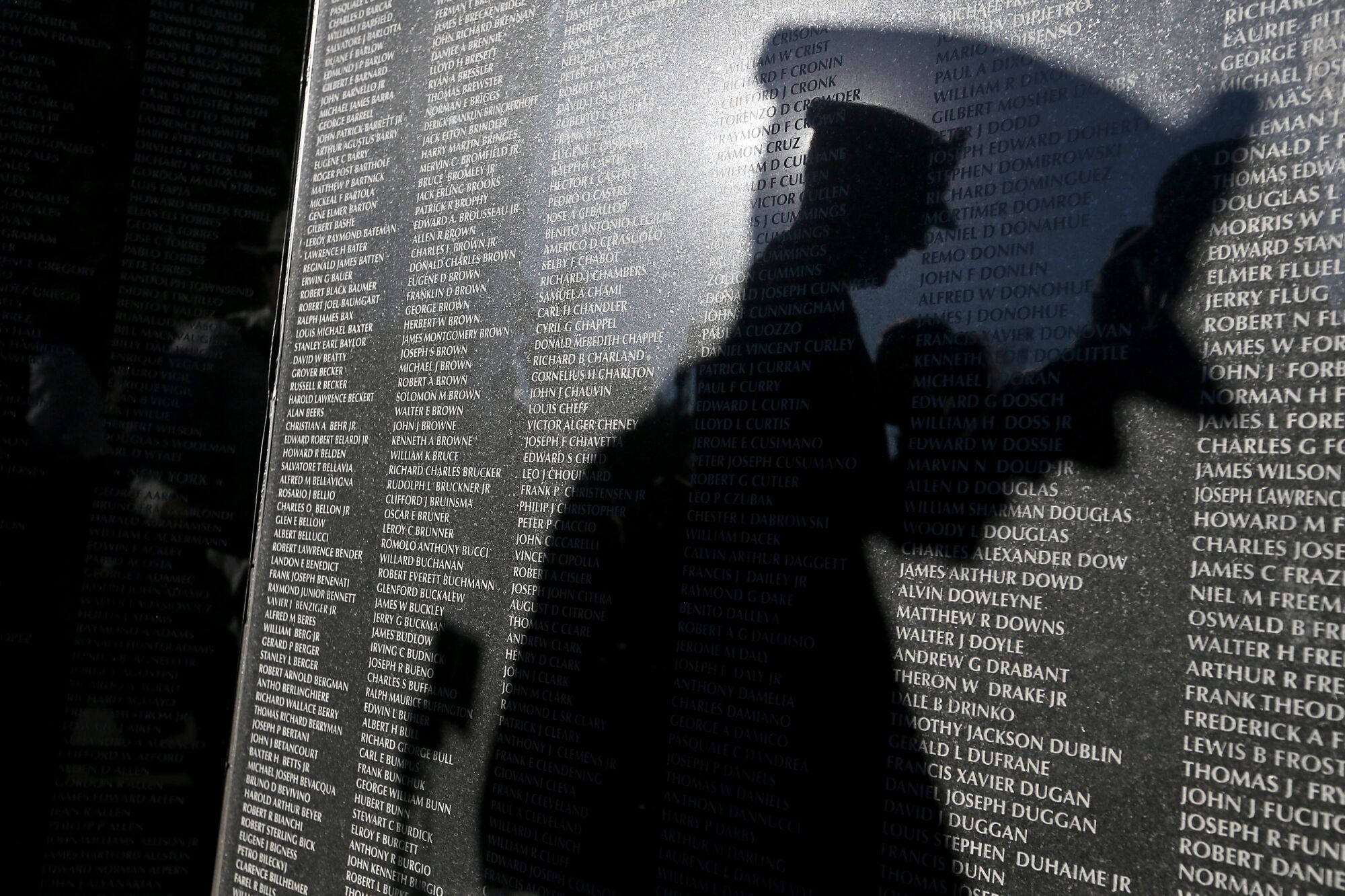 The shadow of Army Brig. Gen. Robert Wooldridge is cast on the Korean War memorial at Hillcrest Park on Veterans Day. 