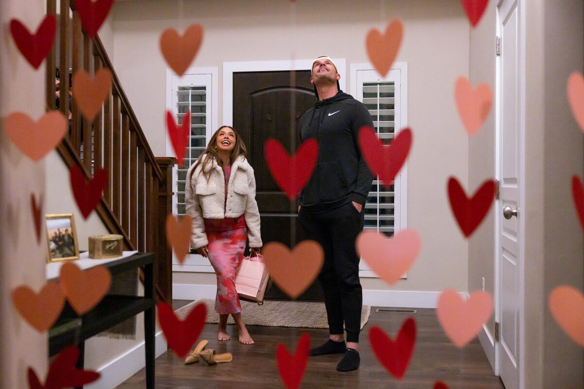 A woman and a man look at Valentine's Day decorations.