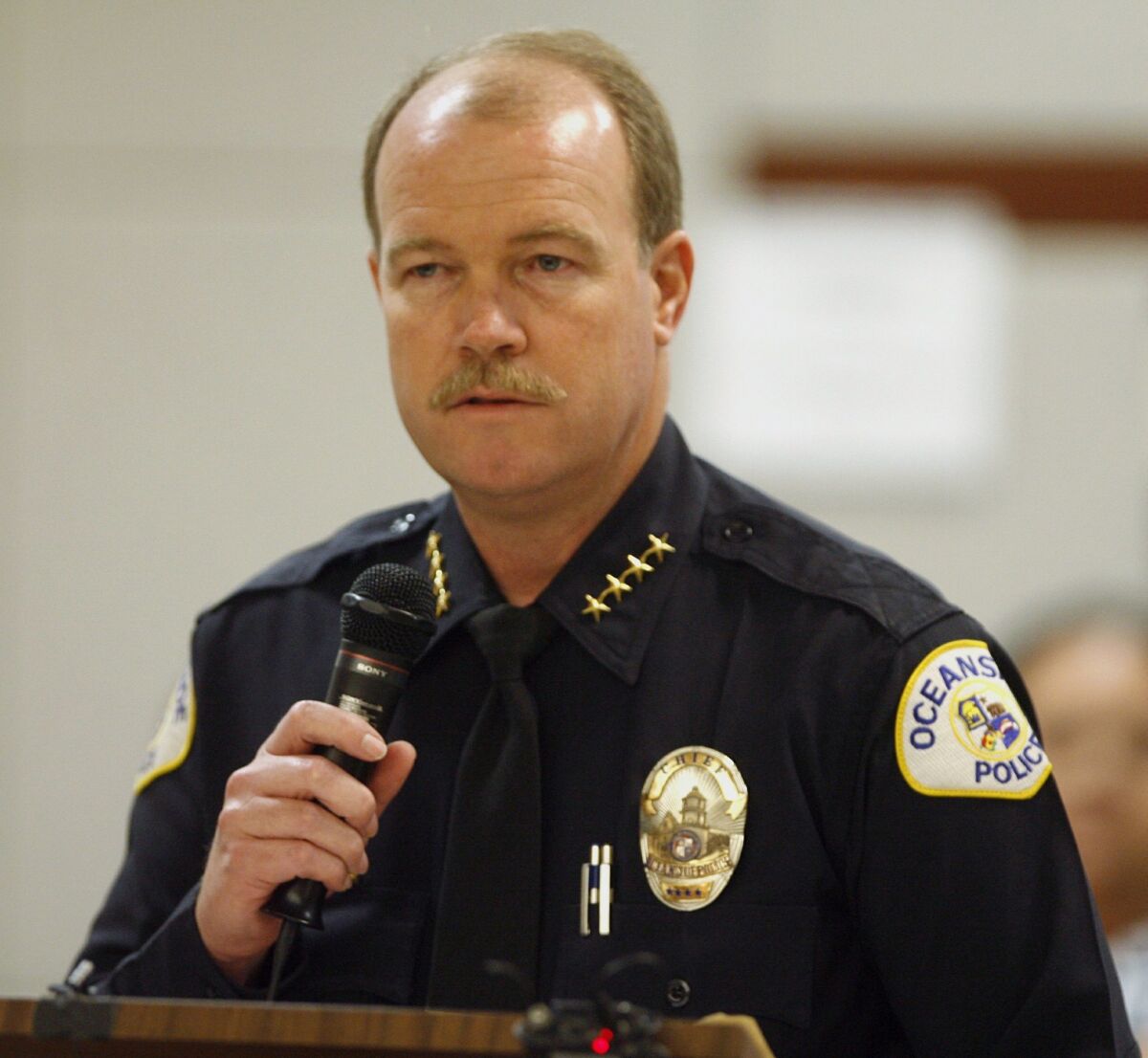 Oceanside Police Chief Frank McCoy speaks during a sentencing at the Vista courthouse in 2009. 