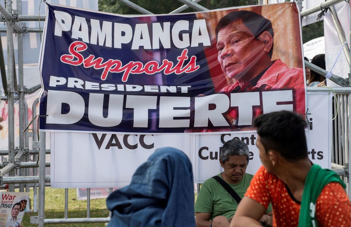 Demonstrators on Sunday attend an overnight vigil in Manila to show their support for Philippine President Rodrigo Duterte's drug crackdown.