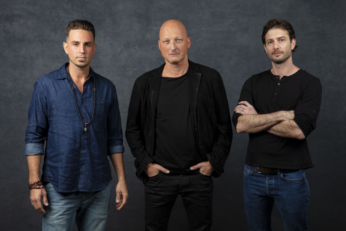 Wade Robson, left, director Dan Reed and James Safechuck from the documentary "Leaving Neverland."