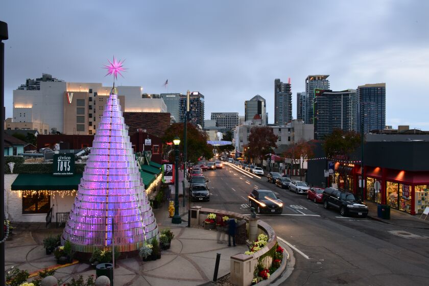 Little Italy’s Christmas tree stands over 30-feet tall.
