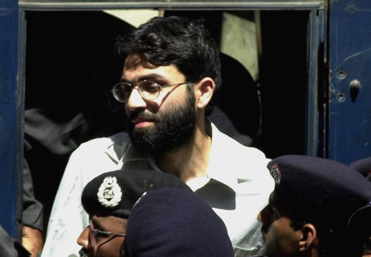 FILE - In this March 29, 2002, file photo, Ahmed Omar Saeed Sheikh, the alleged mastermind behind the Wall Street Journal reporter Daniel Pearl's kidnap-slaying, appears at the court in Karachi, Pakistan. Pakistan's Supreme Court is to hear an appeal Monday, Sept. 28, 2020, by the family of slain American journalist Daniel Pearl that challenges the acquittal of a British-born Pakistani in the gruesome 2002 beheading of the Wall Street Journal reporter. (AP Photo/Zia Mazhar, File)