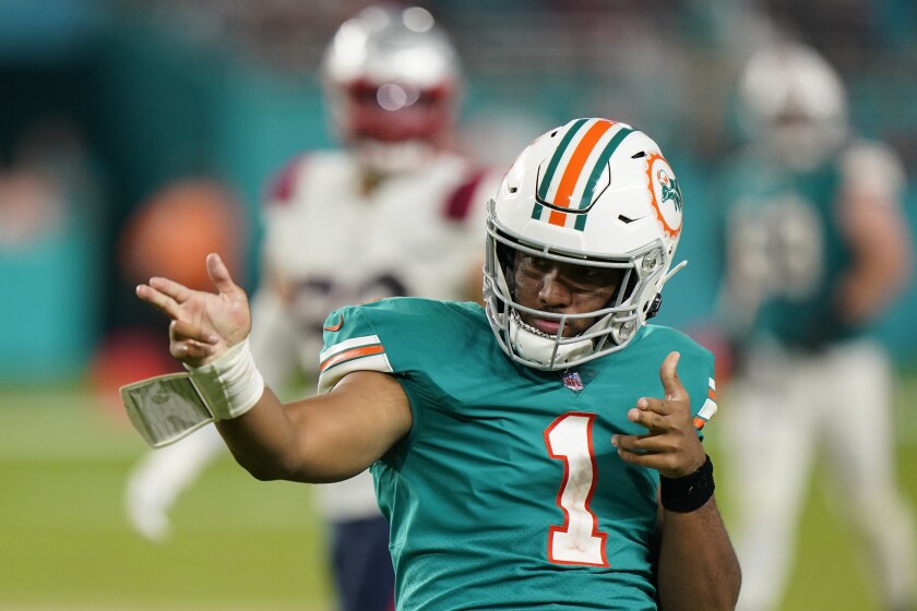 Miami Dolphins quarterback Tua Tagovailoa (1) celebrates after running to gain yardage, during the second half of an NFL football game against the New England Patriots, Sunday, Jan. 9, 2022, in Miami Gardens, Fla. (AP Photo/Wilfredo Lee)