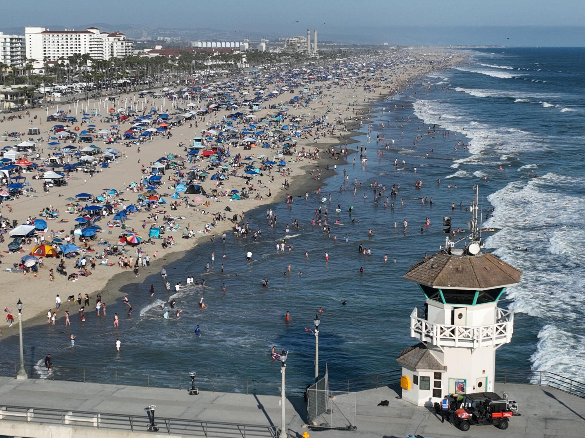 Thousands of beachgoers packed the shoreline to celebrating Independence Day in Huntington Beach.