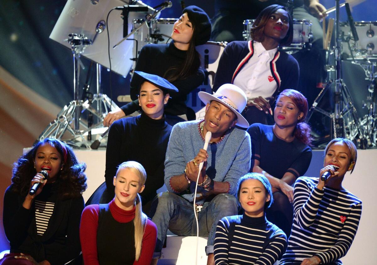 Pharrell Williams, center, performs at the taping of "A Very Grammy Christmas" at the Shrine Auditorium in Los Angeles on Nov. 18.