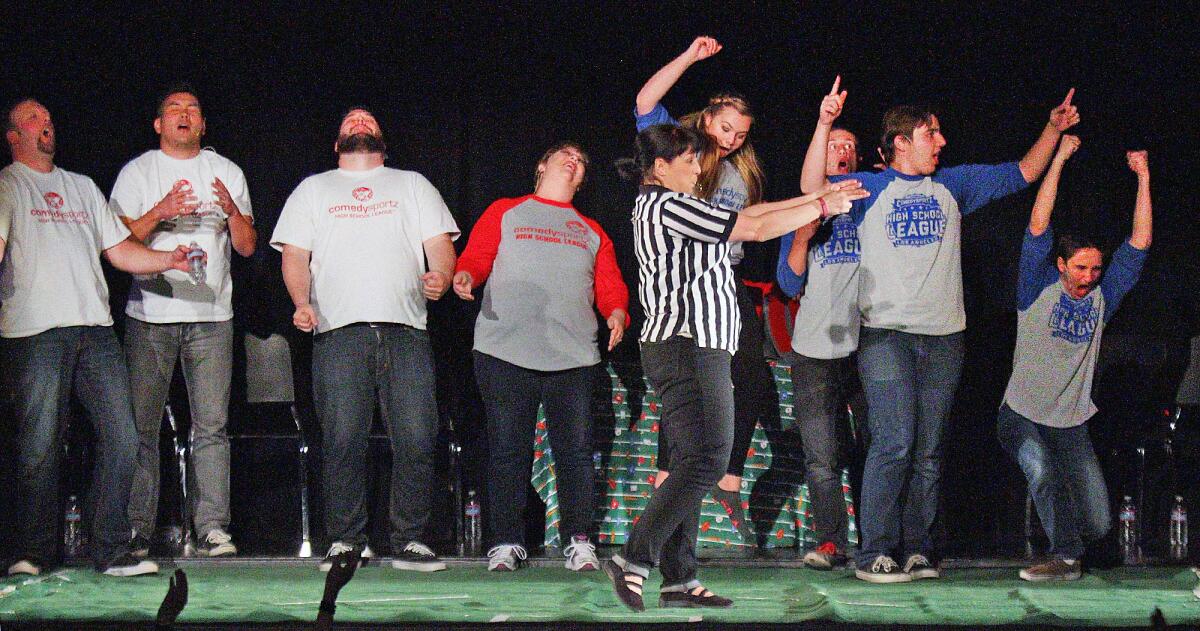 From left, teachers Gavin Hall, David Seiler, Kevin Markor, and Janie Antista all react with sorrow as referee Jen Bascom points in the direction of students Nicole Marks, Mathew Bomar, Luke Naoumovich and Zach Cicciarelli. The student team were in the lead at half time in a ComedySportz varsity vs. faculty improv comedy challenge in the MacDonald Auditorium at Crescenta Valley High School on Friday, April 15, 2016.