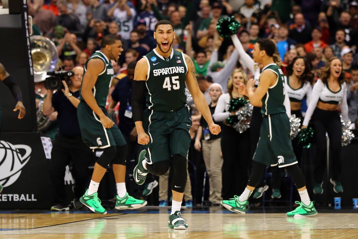 Michigan State guard Denzel Valentine (45) celebrates after the Spartans defeated Oklahoma, 62-58, in an East Regional semifinal game on Friday night in Syracuse, N.Y.