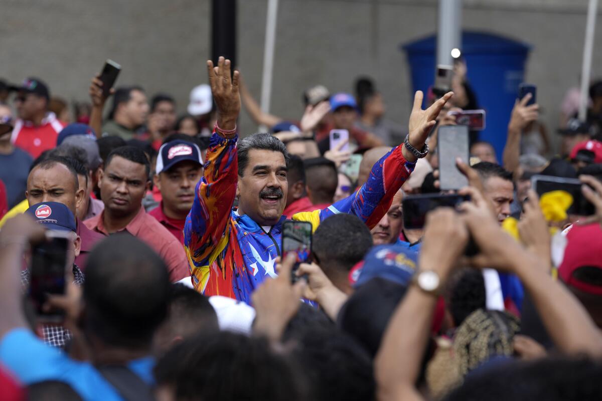 Venezuelan President Nicolas Maduro greets young supporters in Caracas.