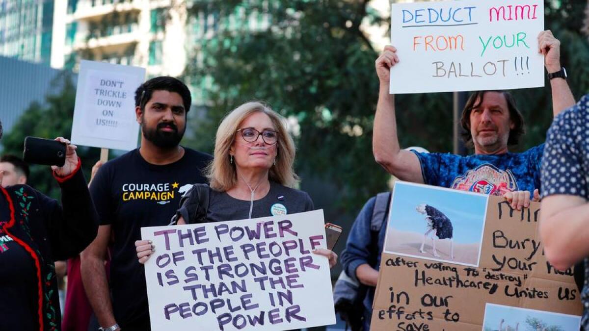 Activists with several California groups rally outside Rep. Mimi Walters' Irvine office.