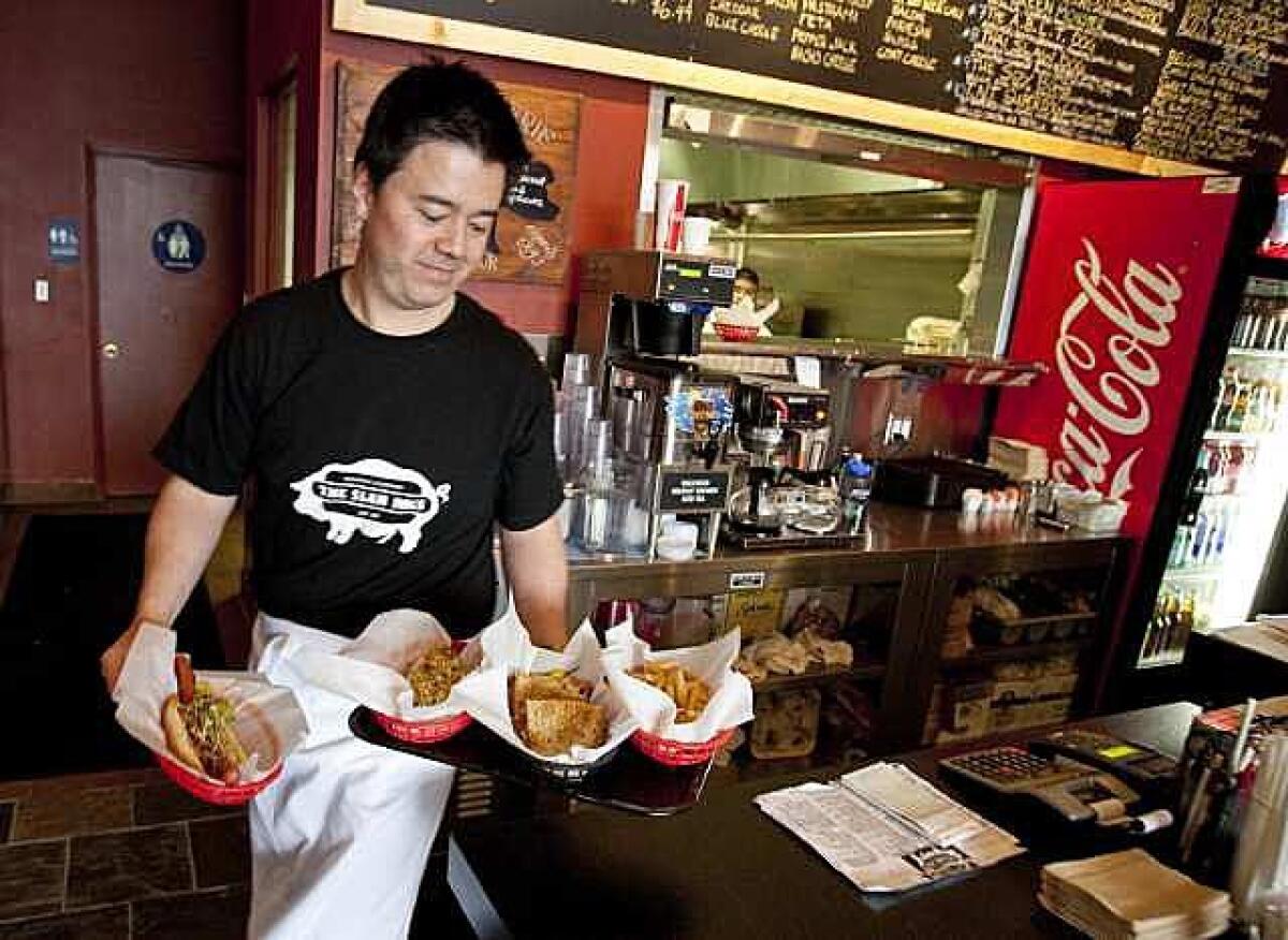 Slaw Dogs owner Ray Byrne serves up a few of his specialties.