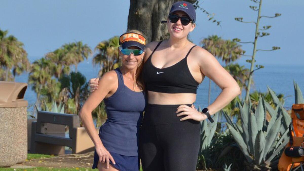 Running coach, Kelly Leonard, left, with client, Jasmine Parniani stand together at Lookout Point in Corona del Mar.