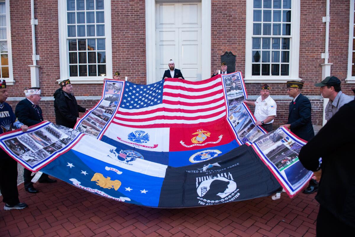 Philadelphia VFW members and veterans unfurl America’s Heroes Flag Art at historic Independence Hall.