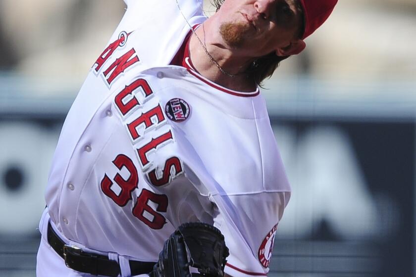 Angels starter Jered Weaver delivers a pitch during the first inning of the Angels' 3-0 victory over the Boston Red Sox on Sunday.