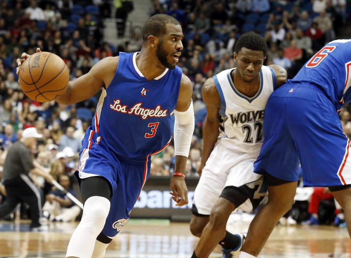 Clippers point guard Chris Paul (3) drives to the basket after getting a pick from center DeAndre Jordan (6) on Timberwolves forward Andrew Wiggins.