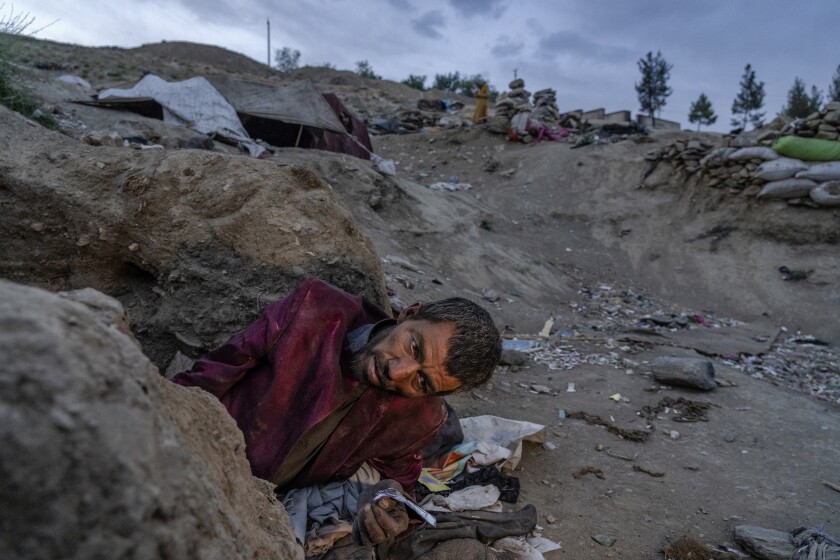 An Afghan drug addict smokes heroin on the edge of a hill in the city of Kabul, Afghanistan,Tuesday, June 7, 2022. Drug addiction has long been a problem in Afghanistan, the world’s biggest producer of opium and heroin. The ranks of the addicted have been fueled by persistent poverty and by decades of war that left few families unscarred. (AP Photo/Ebrahim Noroozi)