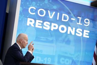 President Biden speaks in front of a blue screen that says "COVID-19 response." 