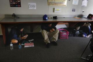 Howard Lipin  U-T file PHOTOS Valley High School students hide under a desk during an active-shooter drill at the school in 2018.