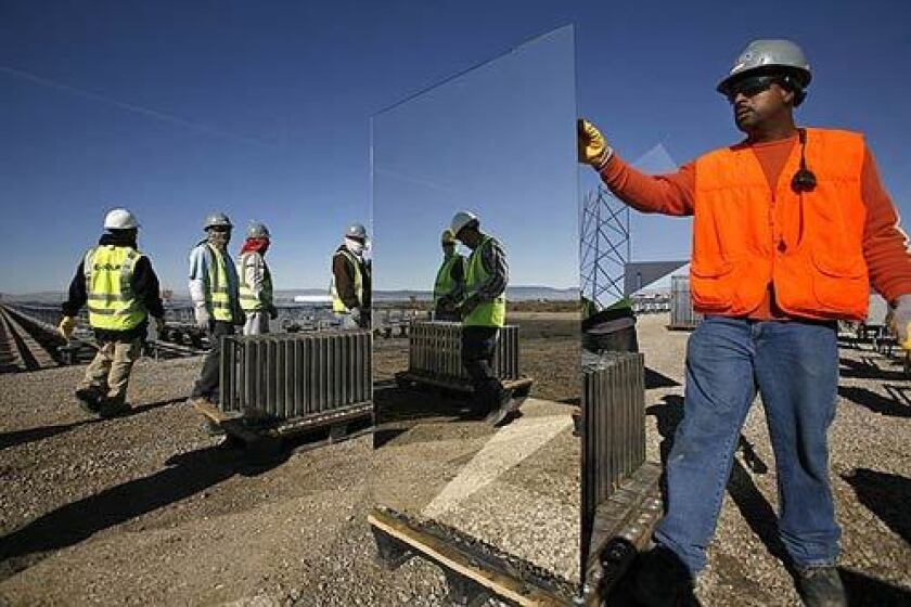 Workers install mirrors at an eSolar demonstration plant in Lancaster. The city hopes the company will provide jobs for Antelope Valley residents.