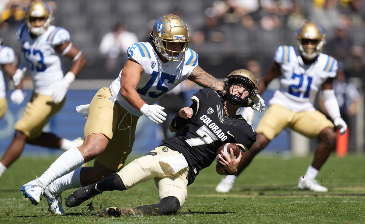 UCLA linebacker Laiatu Latu sacks Colorado quarterback Owen McCown on Sept. 24, 2022.