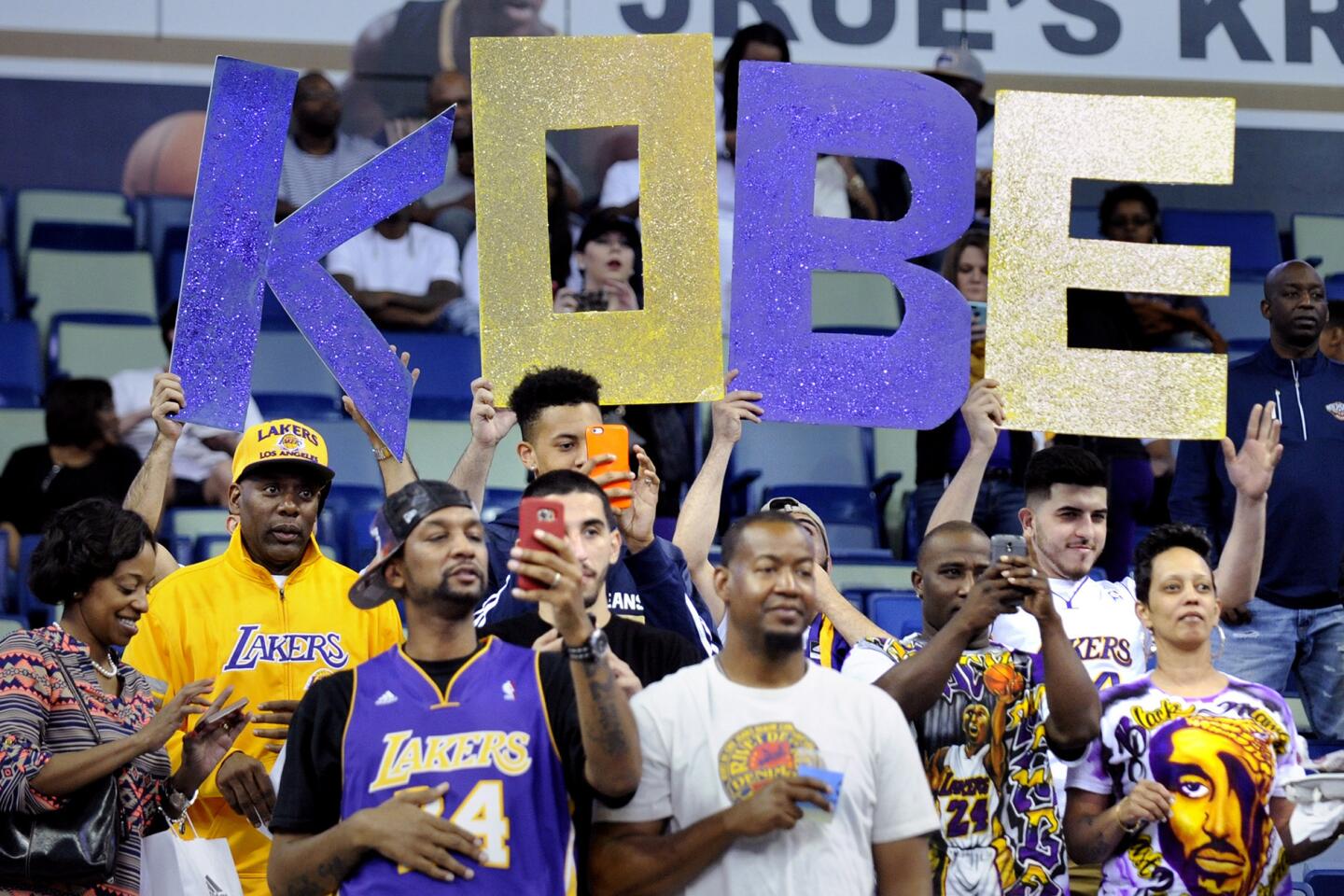 Fans hold a 'KOBE' sign as the Lakers take the court at Smoothie King Center in New Orleans.
