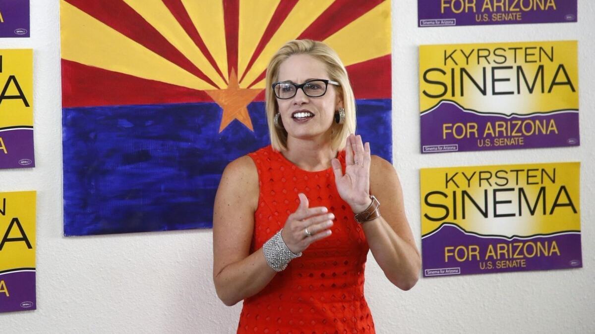 Rep. Kyrsten Sinema, D-Ariz., talks to campaign volunteers at a Democratic campaign office on Aug. 28 in Phoenix.