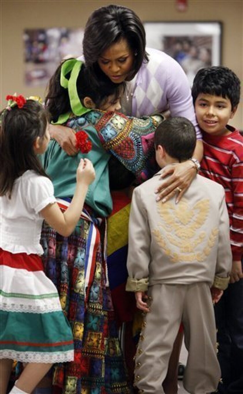 First lady Michelle Obama is greeted by school children as she visits the Latin American Montessori Bilingual Public Charter School in celebration of Cinco de Mayo, Monday, May 4, 2009, in Washington. (AP Photo/Haraz N. Ghanbari)