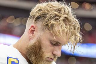 Rams wide receiver Cooper Kupp (10) hangs his head in Arizona before a game against the Cardinals.