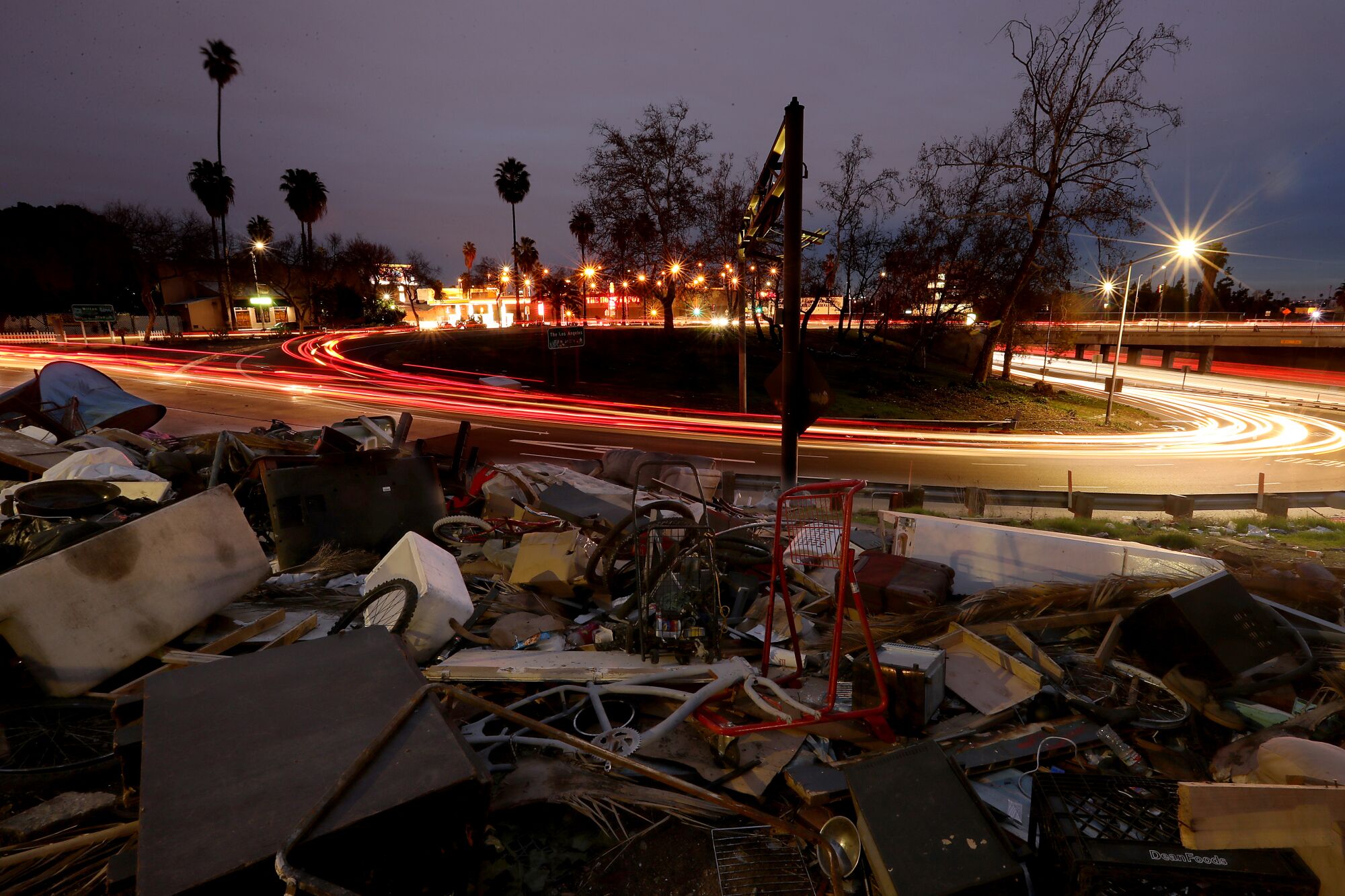 Debris from a homeless encampment piles up near the Hollywood Freeway