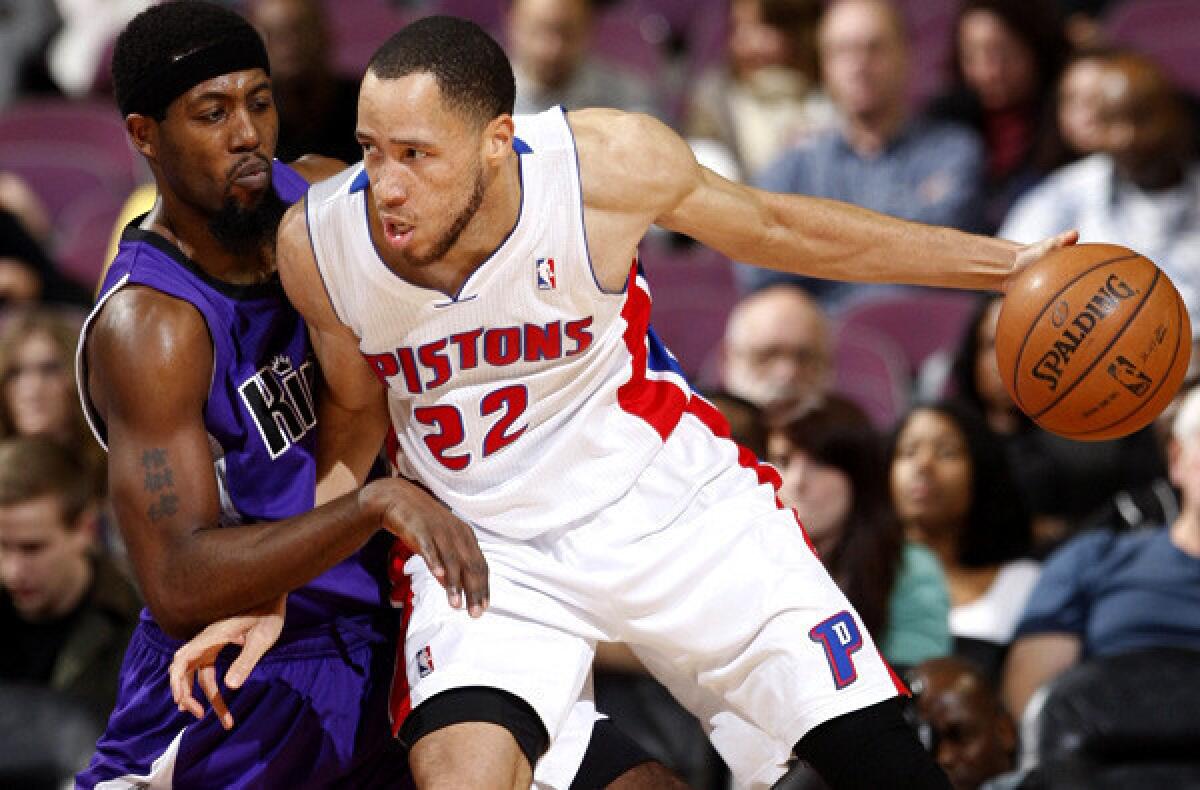 Pistons forward Tayshaun Prince, right, works in the post against Kings guard John Salmons.