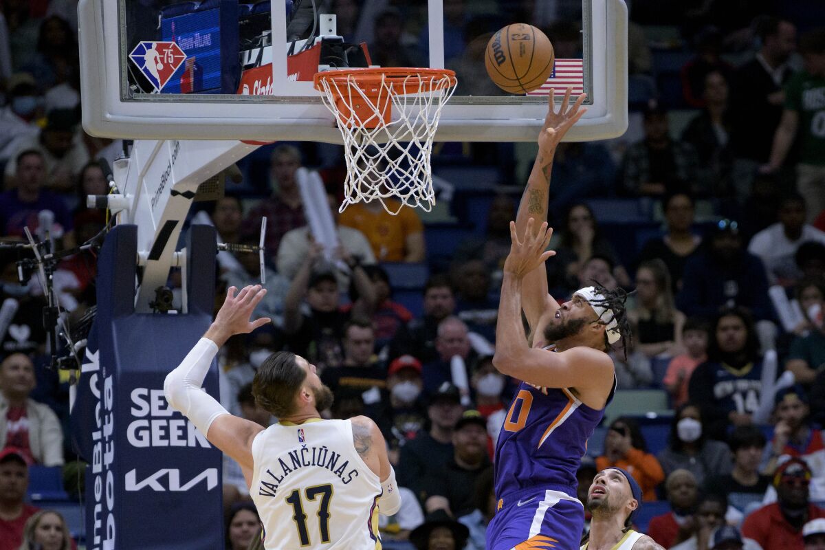 Phoenix Suns center JaVale McGee (00) makes a shot over New Orleans Pelicans center Jonas Valanciunas (17) in the first half of an NBA basketball game in New Orleans, Tuesday, March 15, 2022. (AP Photo/Matthew Hinton)