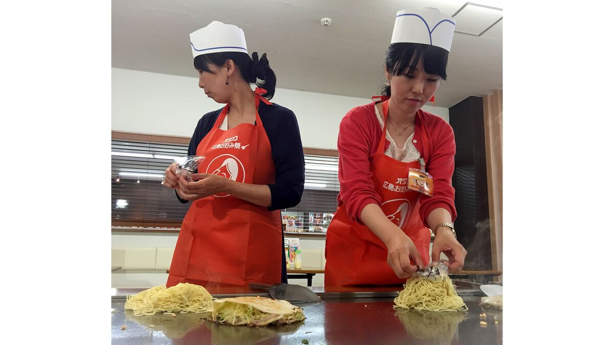 Students learn how to make okonomiyaki at the Otafuku Sauce Co.’s museum and cooking studio in Hiroshima.