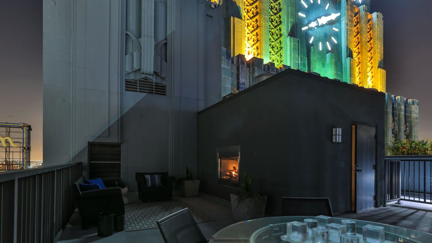 The three-story penthouse in the Eastern Columbia Building features a private terrace with a fireplace.