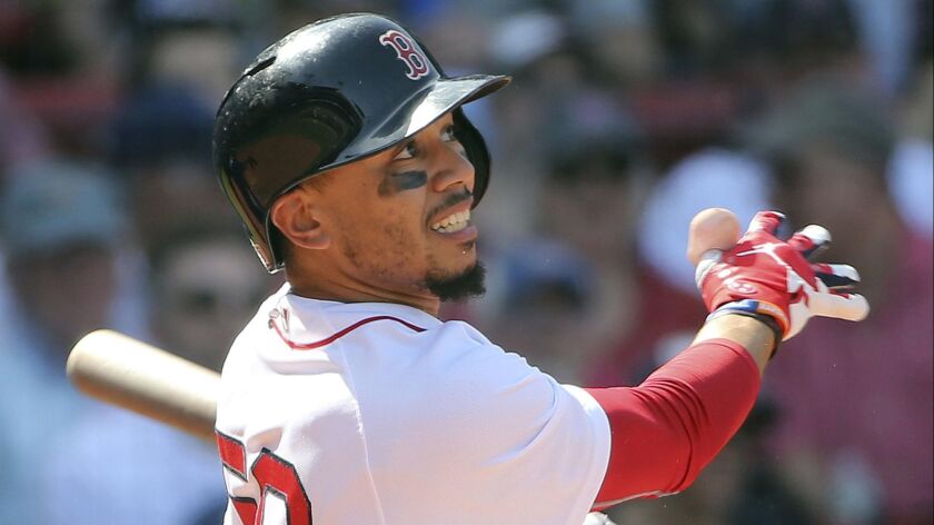 Red Sox outfielder Mookie Betts follows through with his third home run of the game against the Royals during the seventh inning of a game May 2, 2018, in Boston.