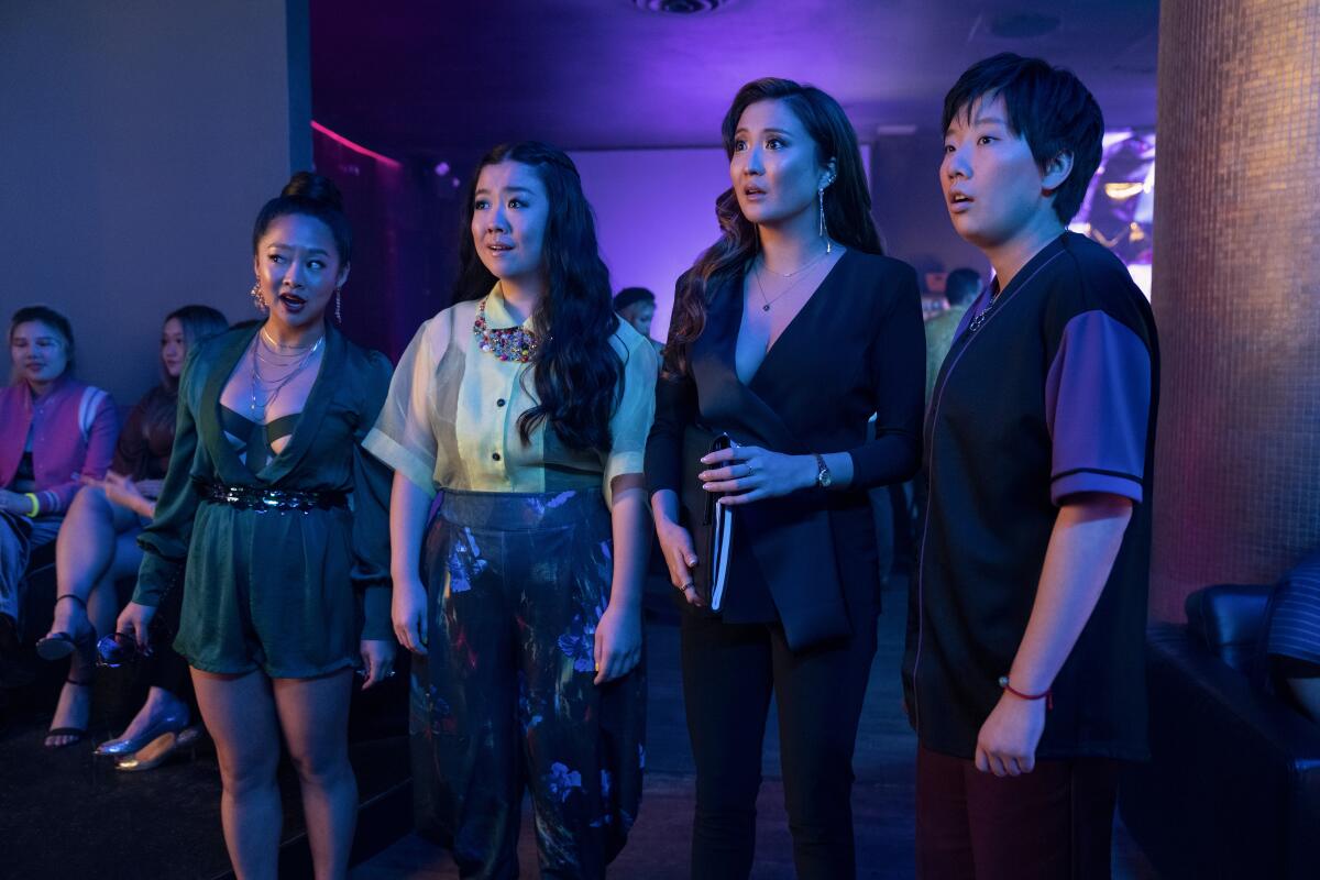 Four women stand in a nightclub