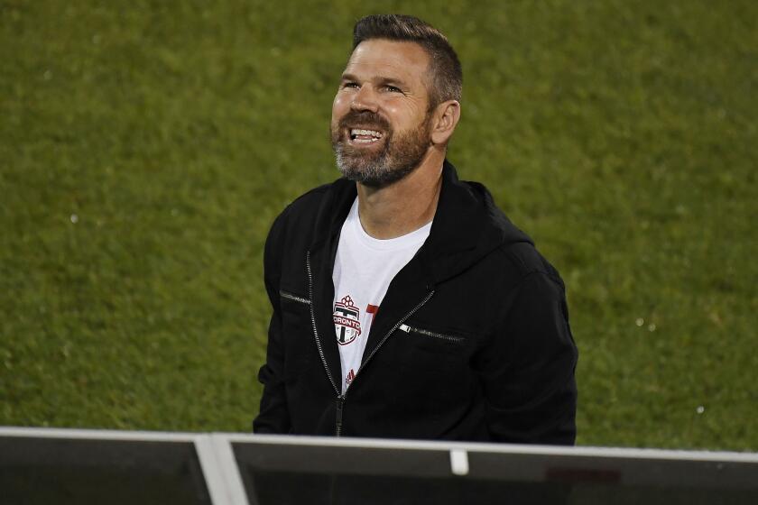 Toronto FC head coach Greg Vanney smiles during the first half of an MLS soccer match against Columbus Crew.