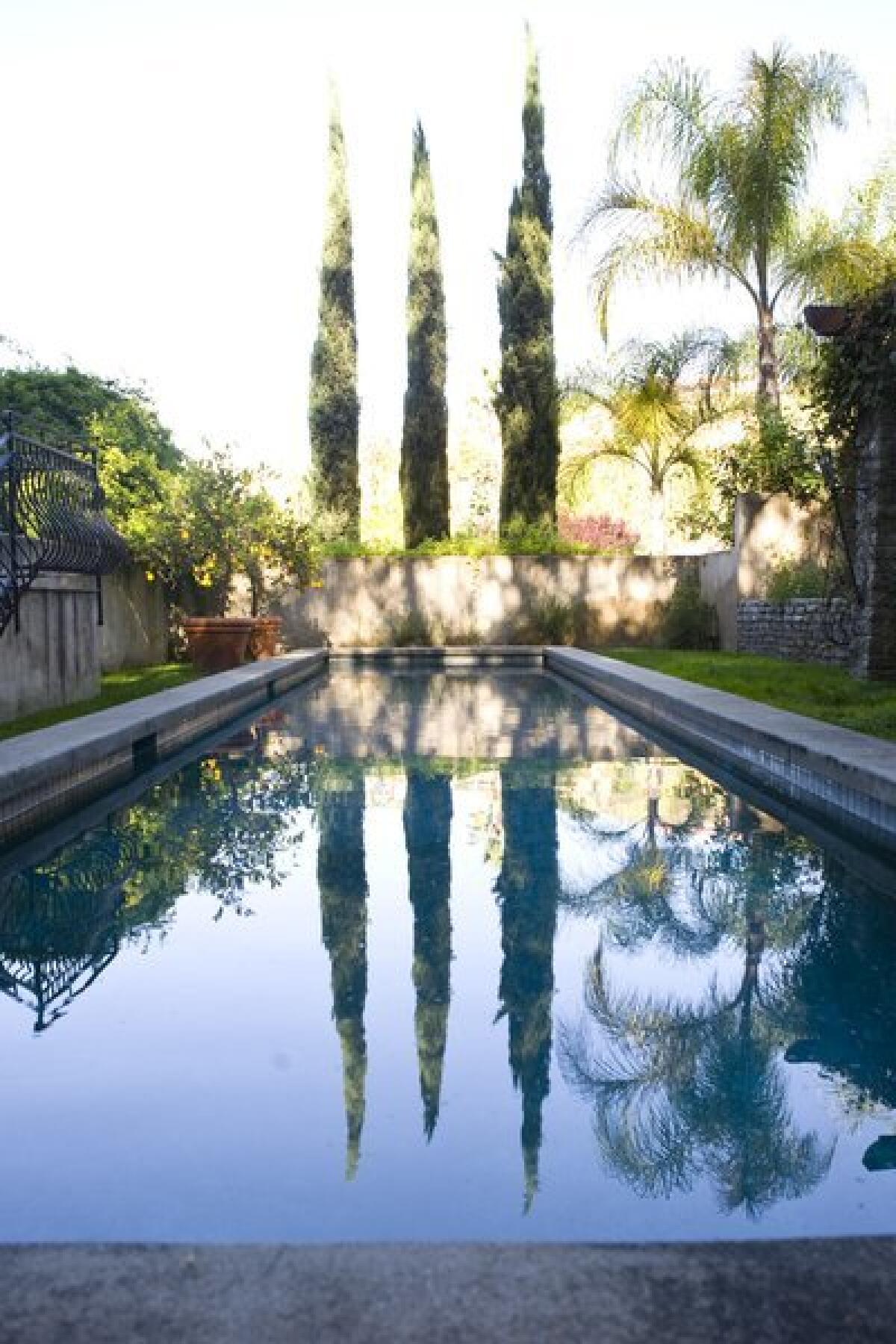 Italian cypress trees are often used as screens between properties; the ones pictured here in a Pasadena garden also provide a nice reflection in the pool. For a reader in the Antelope Valley, the hurdle to healthy trees might be in the soil.