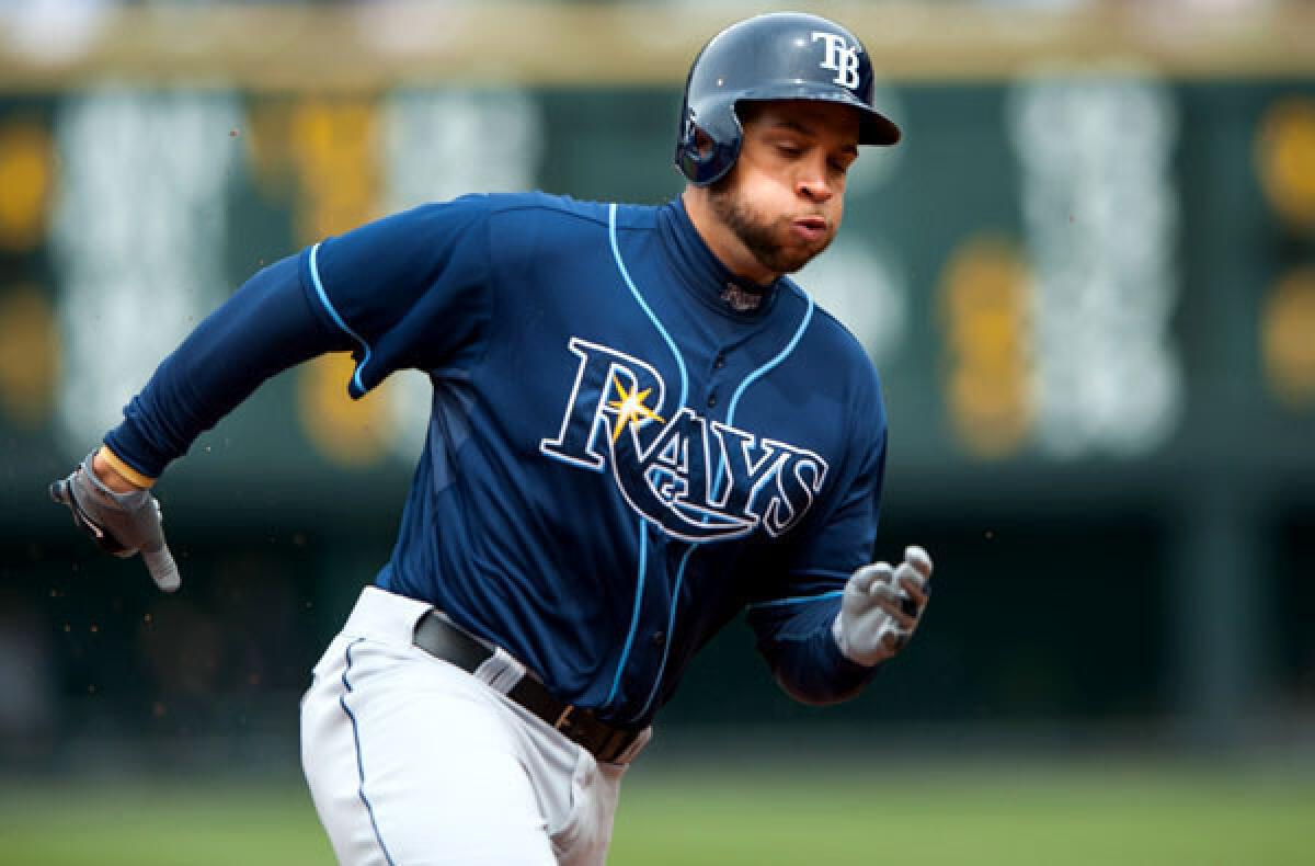 Rays first baseman James Loney rounds third as he scores against the Rockies in a game last week.