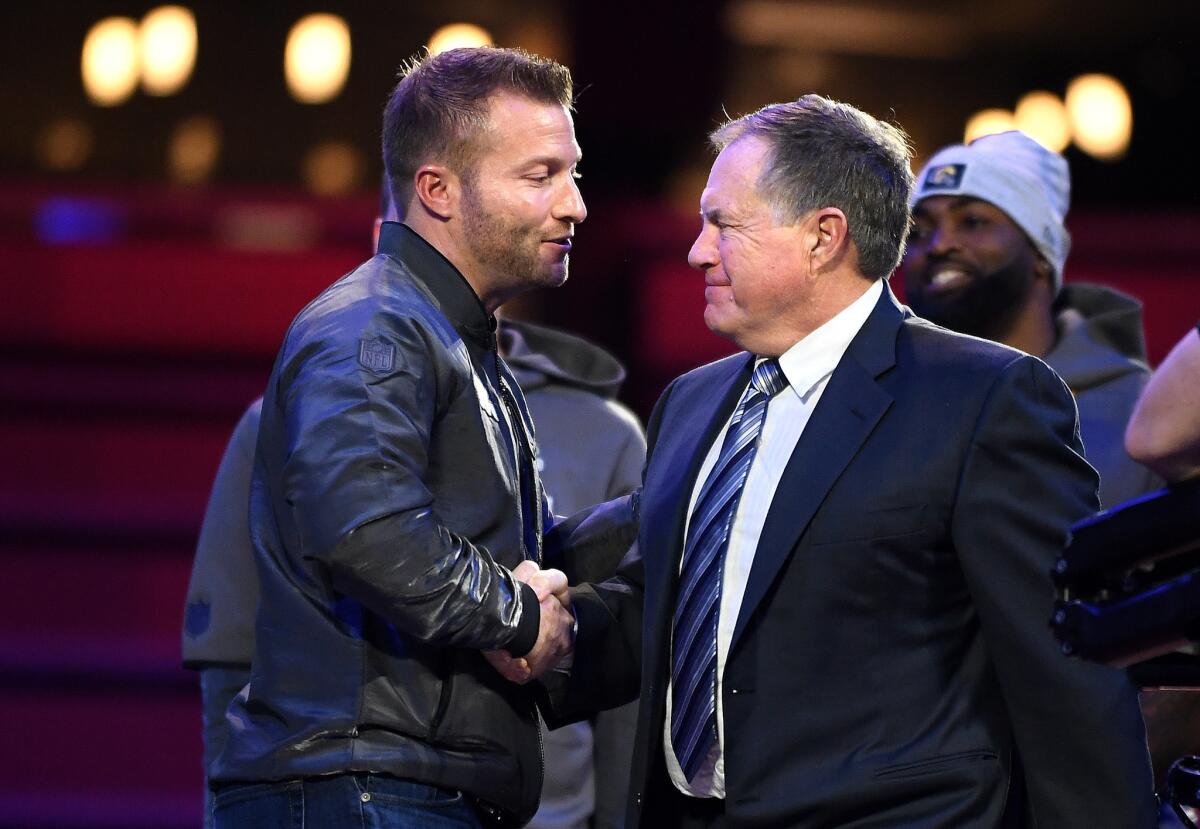 Rams coach Sean McVay and New England Patriots coach Bill Belichick meet on stage during a Super Bowl media day.