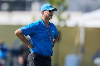 Chargers coach Jim Harbaugh watches from the sideline during training camp at The Bolt. 