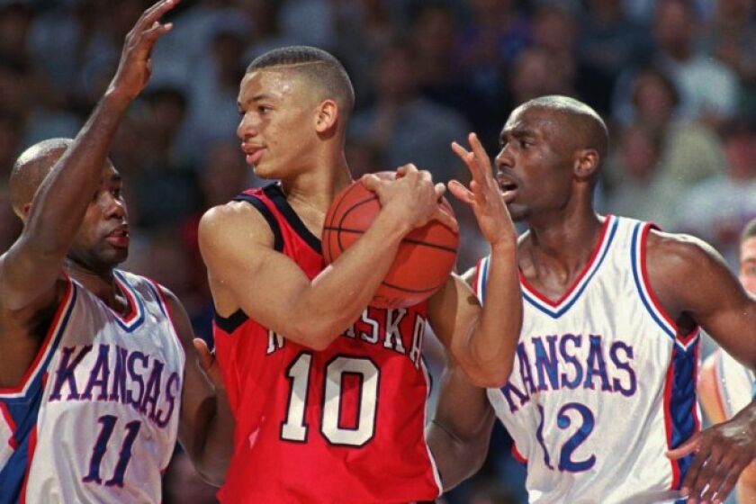 Nebraska's Tyronn Lue is sandwiched between Kansas' Jacque Vaughn (11) and Billy Thomas during a game Feb. 1, 1997.