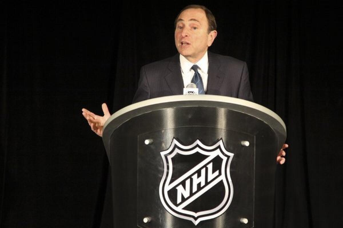 NHL Commissioner Gary Bettman responds to questions during a news conference.
