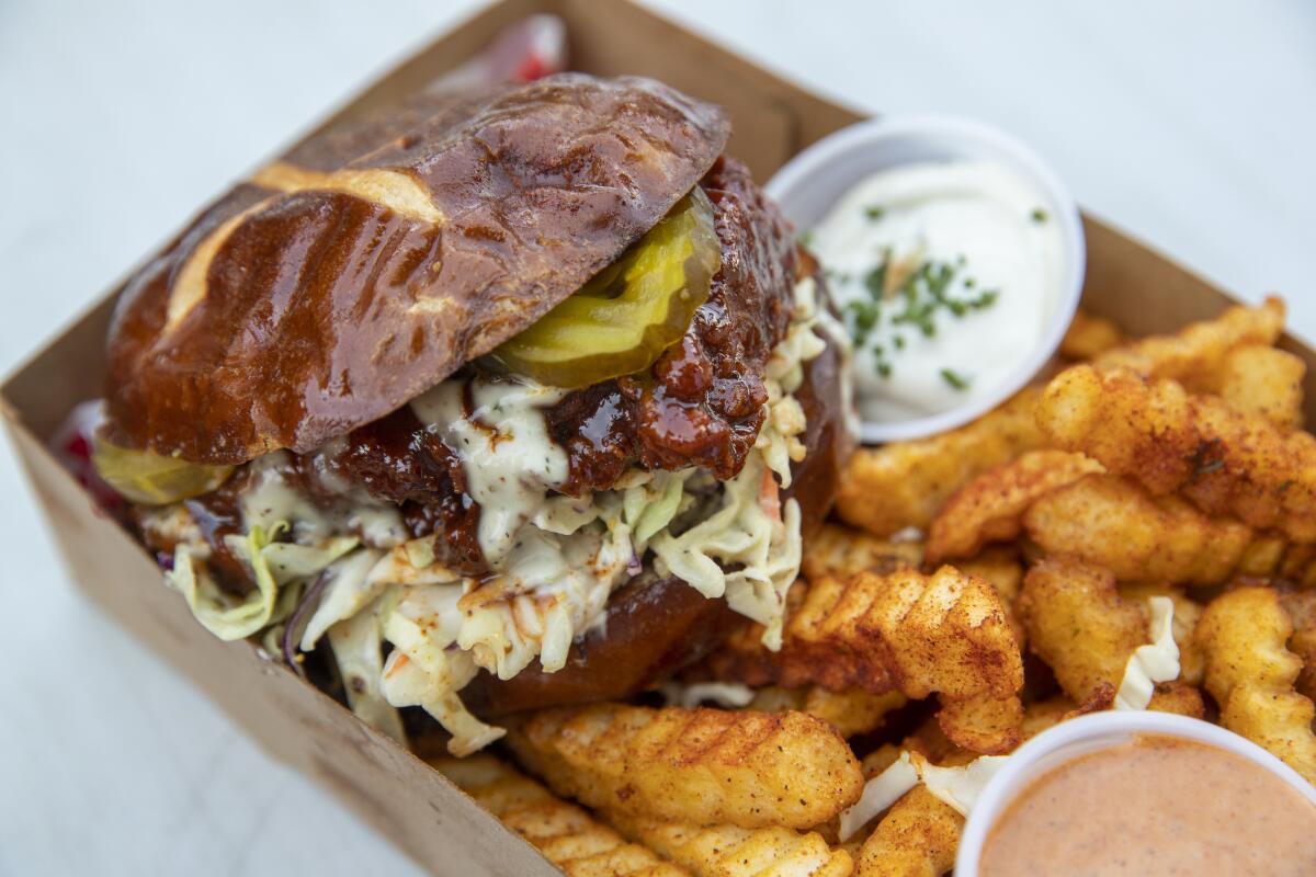 The Nashville Sando — a "Southern chick'n patty" with pickles, slaw, ranch and spicy dip on a bun —  and crinkle-cut fries from Lettuce Feast.