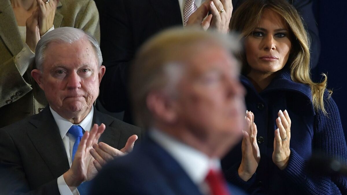 Jeff Sessions and First Lady Melania Trump listen as President Trump speaks to supporters.