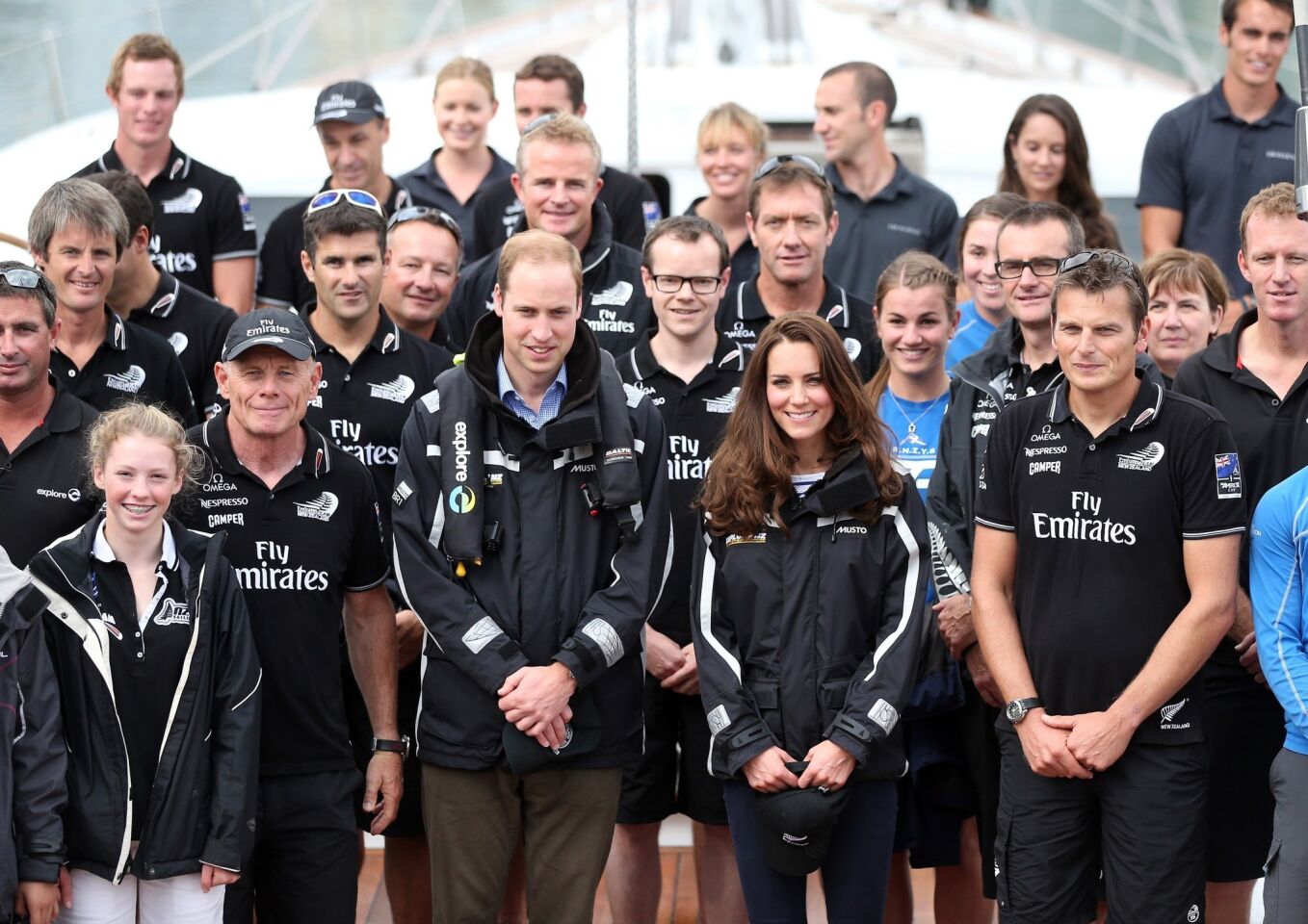 Prince William and Catherine pose with members of Team New Zealand on the yacht Imagine at Auckland Harbor in Auckland on April 11