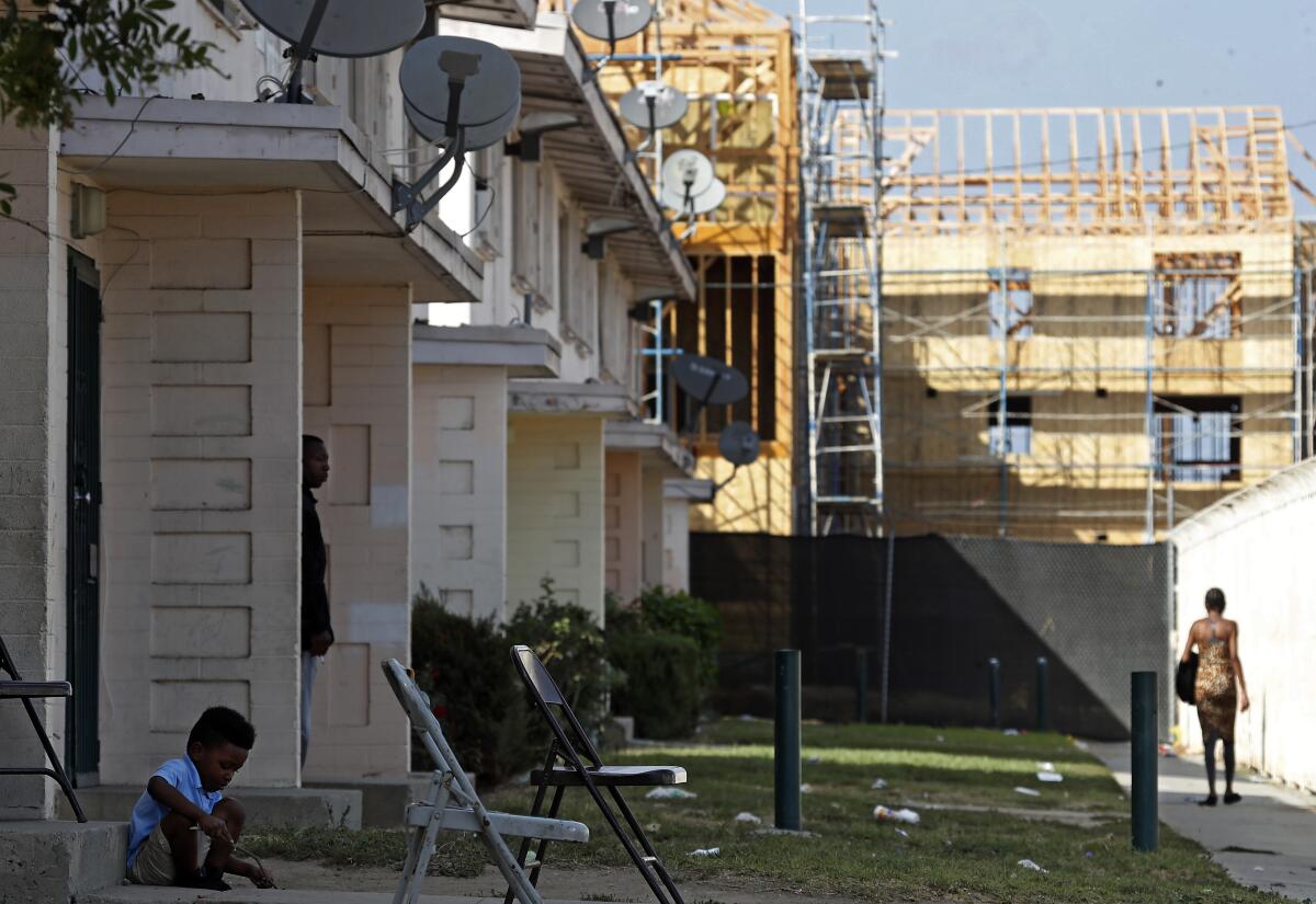 New construction rises near old  units of the Jordan Downs housing project 