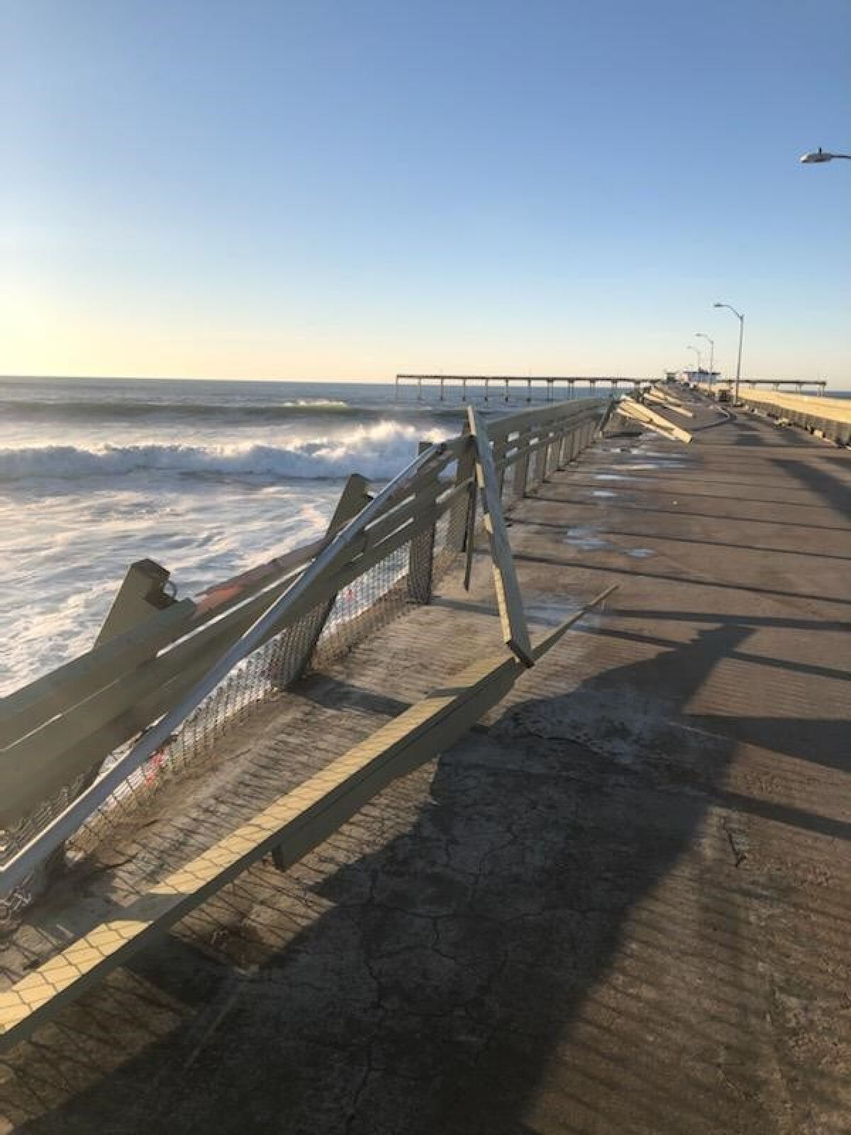 Railings on the south side of the Ocean Beach Pier were damaged by high surf Jan. 11.