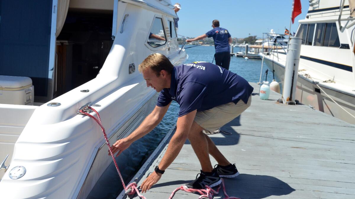 Assistant manager Danny Knowles ties up a boat before it fuels up at Island Marine Fuel on Balboa Island.